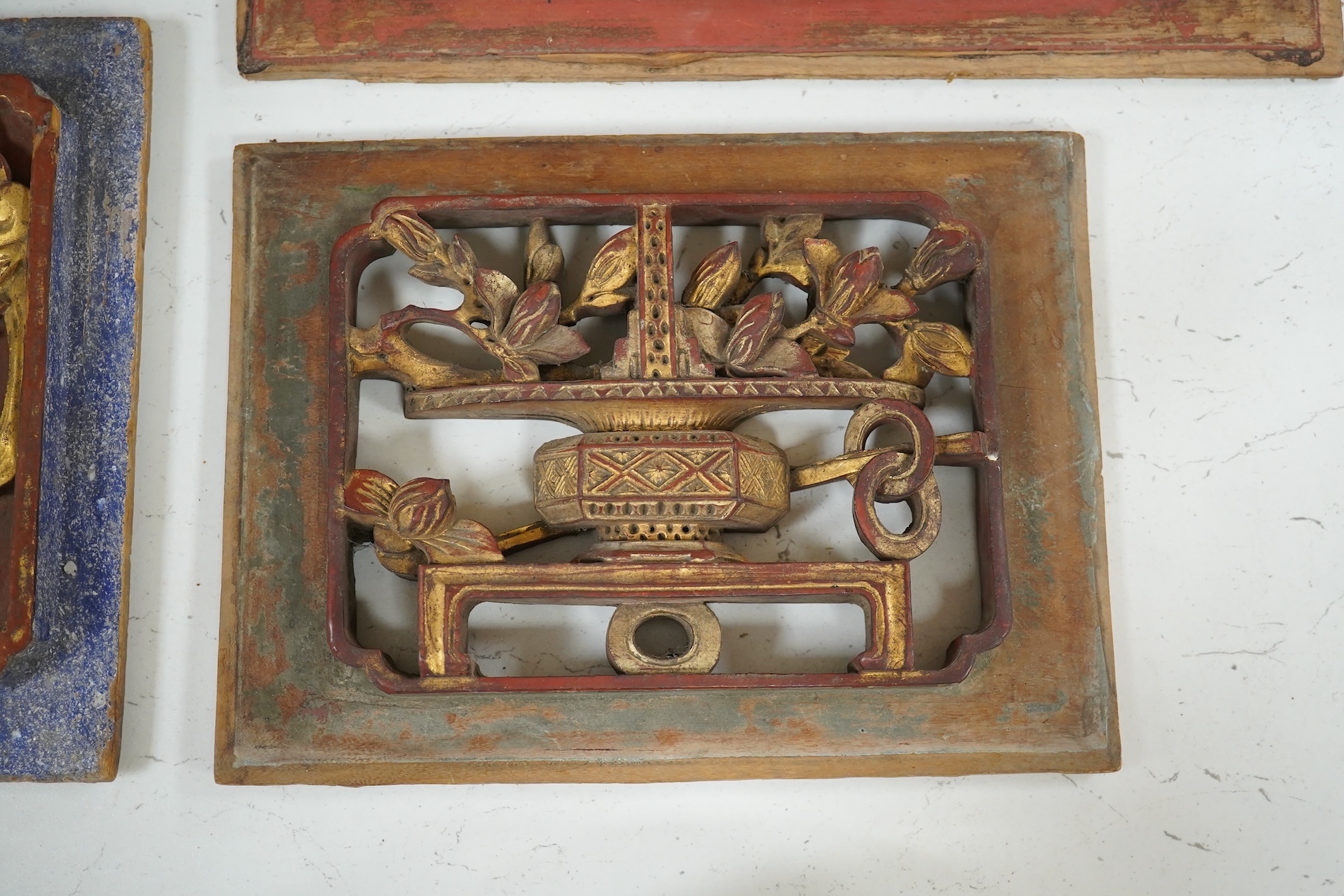 Three Chinese gilded and lacquered wood panels, early 20th century, longest 31cm. Condition - fair